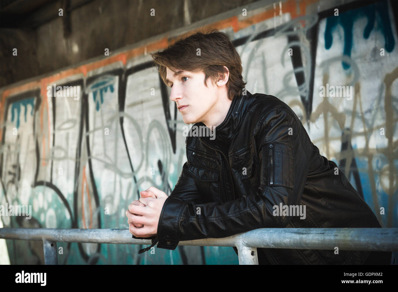 teenager depressed inside a dirty tunnel Stock Photo