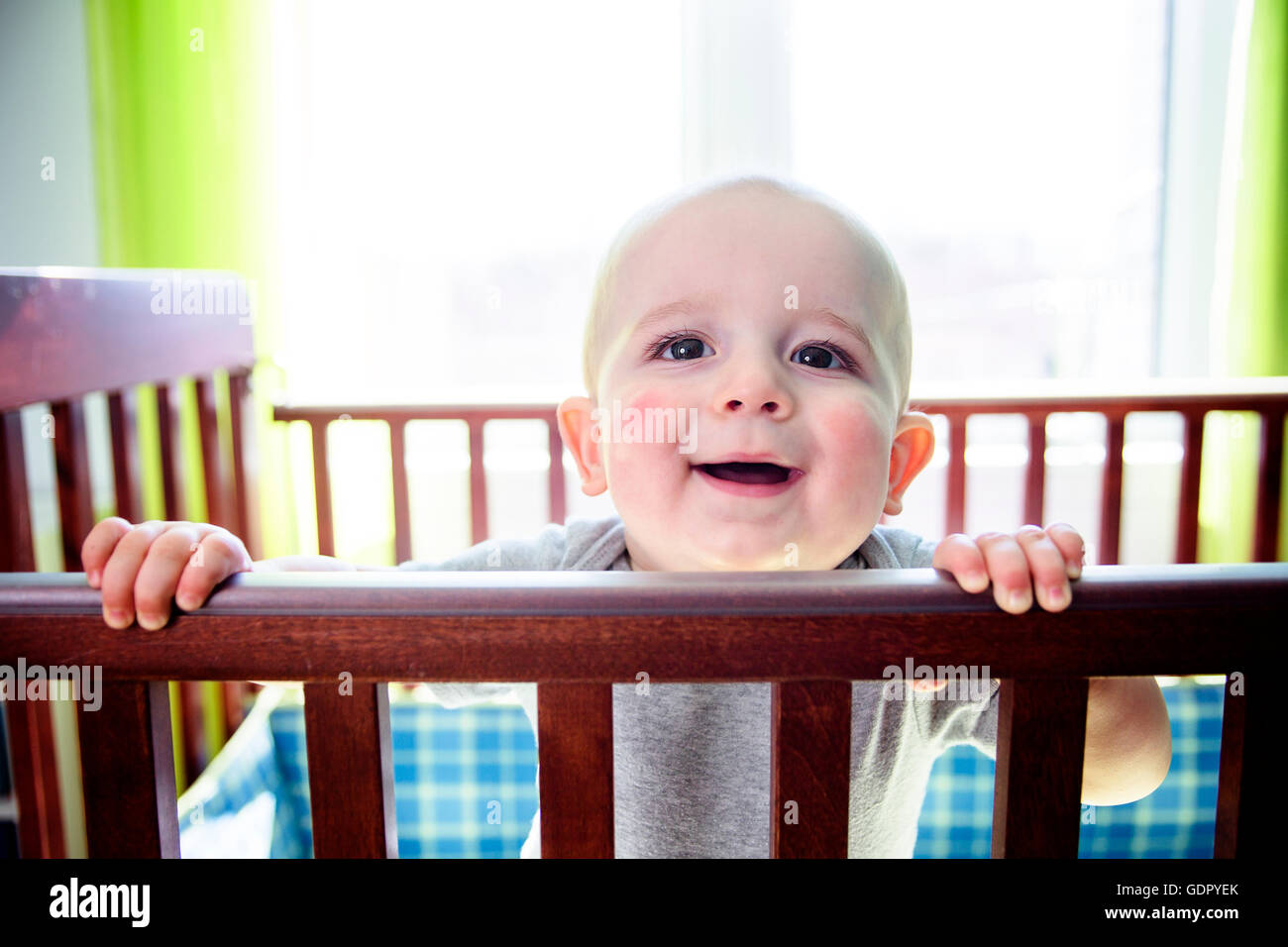 Adorable baby boy in his crib Stock Photo Alamy