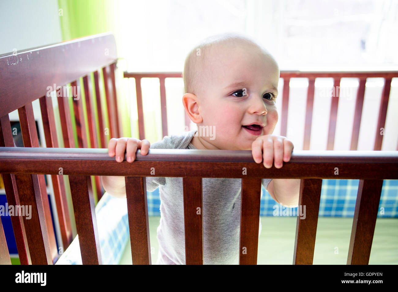 Adorable baby boy in his crib Stock Photo Alamy