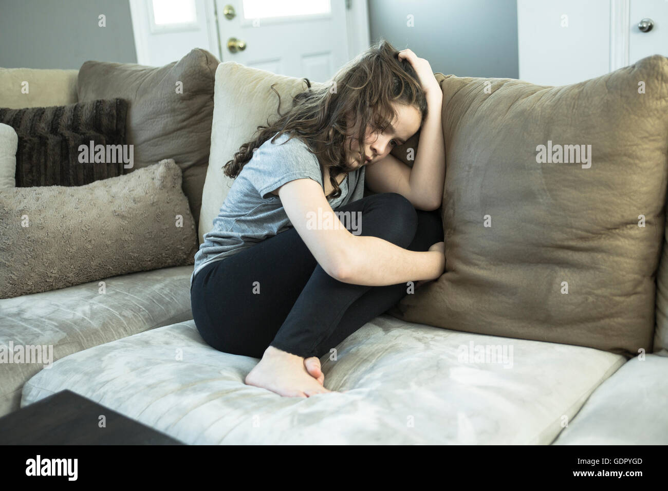 Expression of lonely female teenager at home Stock Photo