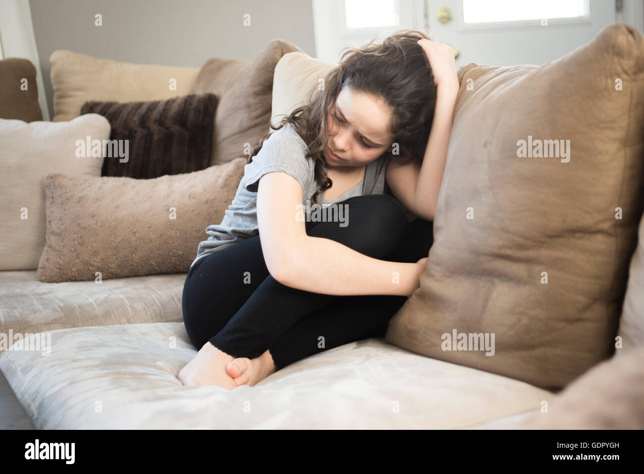 Expression of lonely female teenager at home Stock Photo