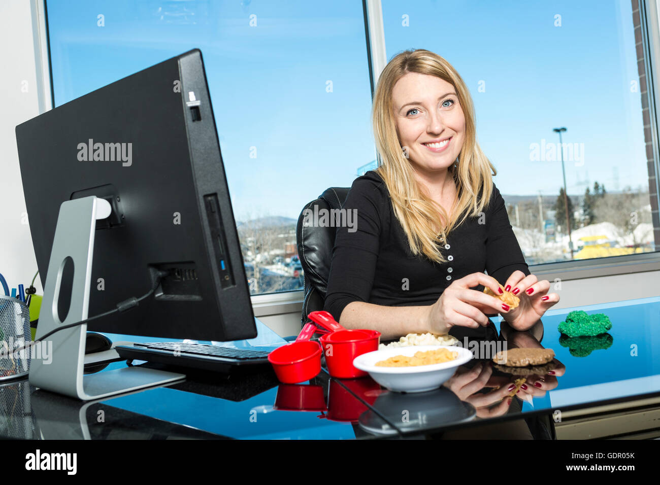 Cute young nutritionist in a office Stock Photo
