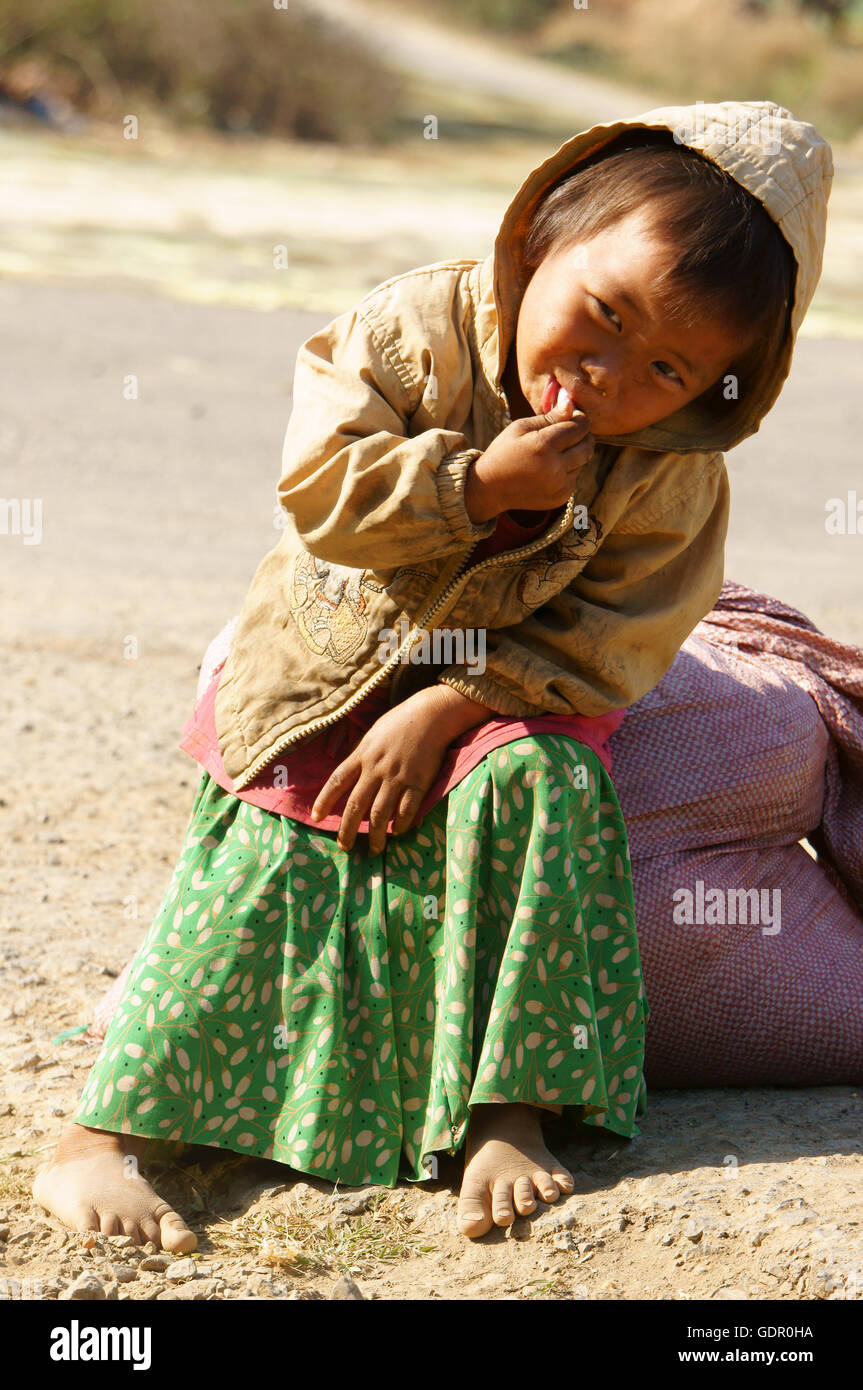 Asian children hungry and eating, dirty clothing, barefoot, poverty child at poor countryside Stock Photo