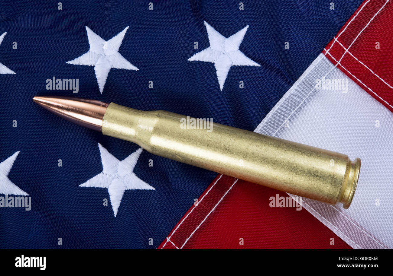 50 caliber brass bullet on American flag with room for your type.. Stock Photo