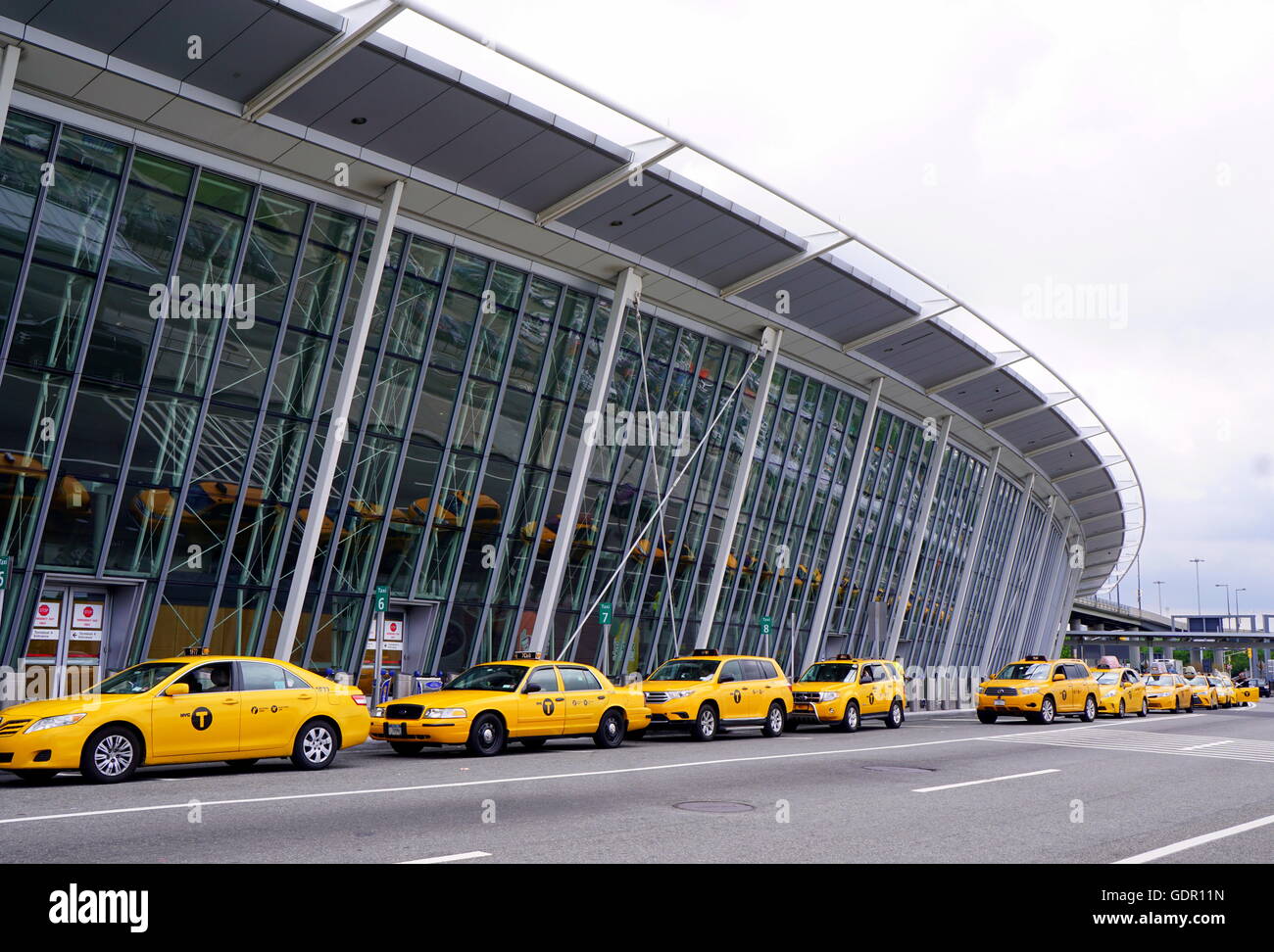 Yellow taxi cabs lining up to pick up customers at JFK Airport, New York City, NY, USA Stock