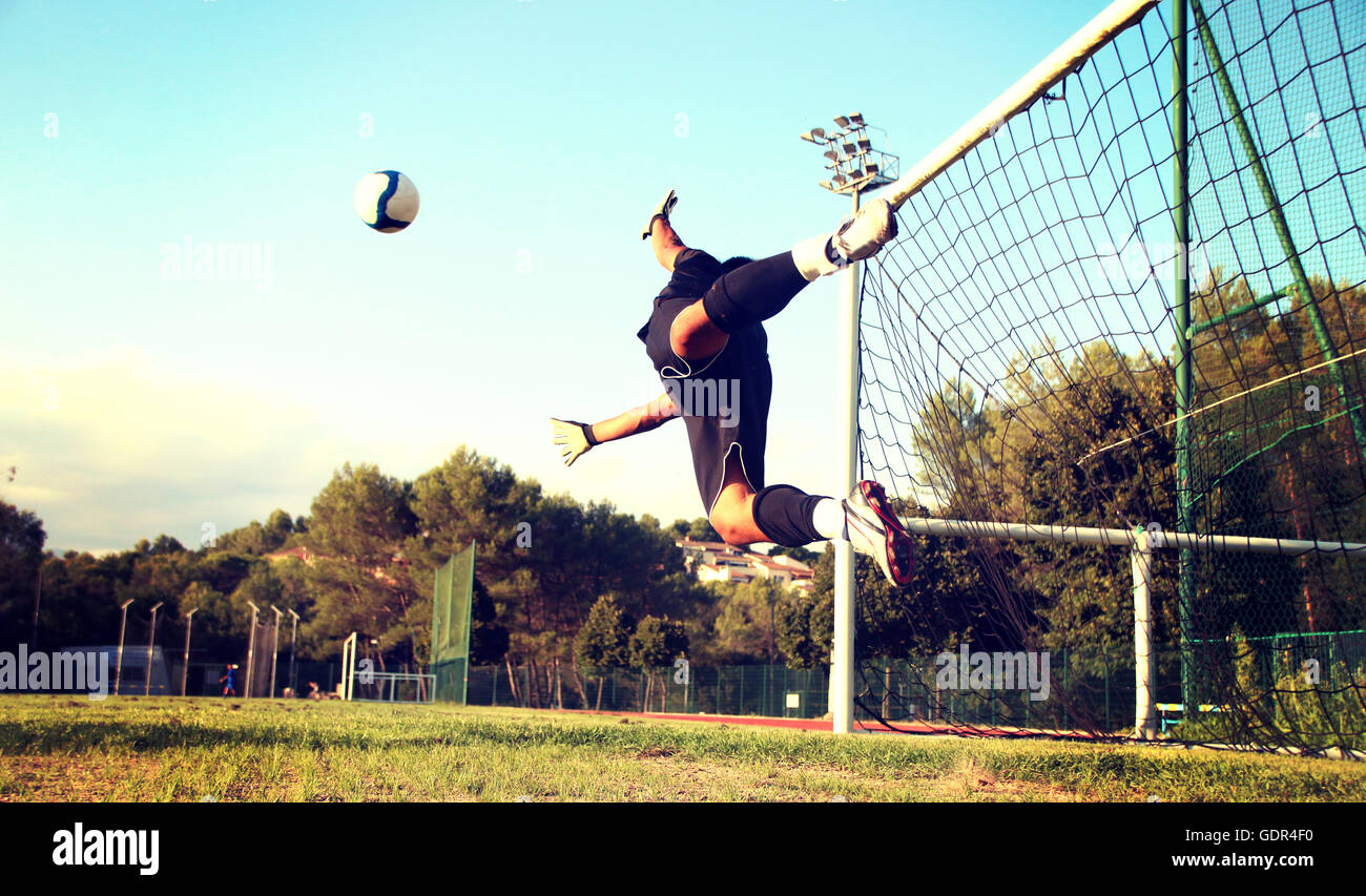 Goalkeeper trying to stop a ball Stock Photo Alamy