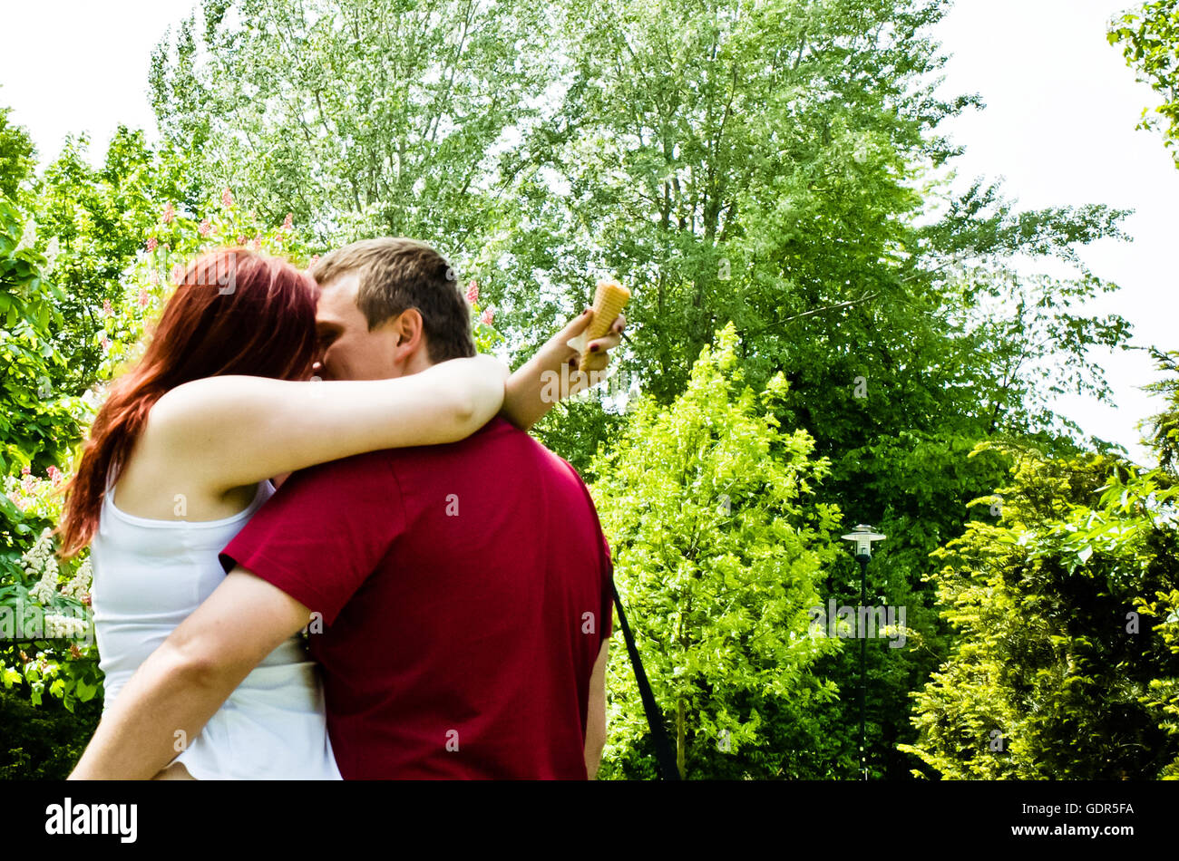 couple of lovers passionately kissing in the park Stock Photo