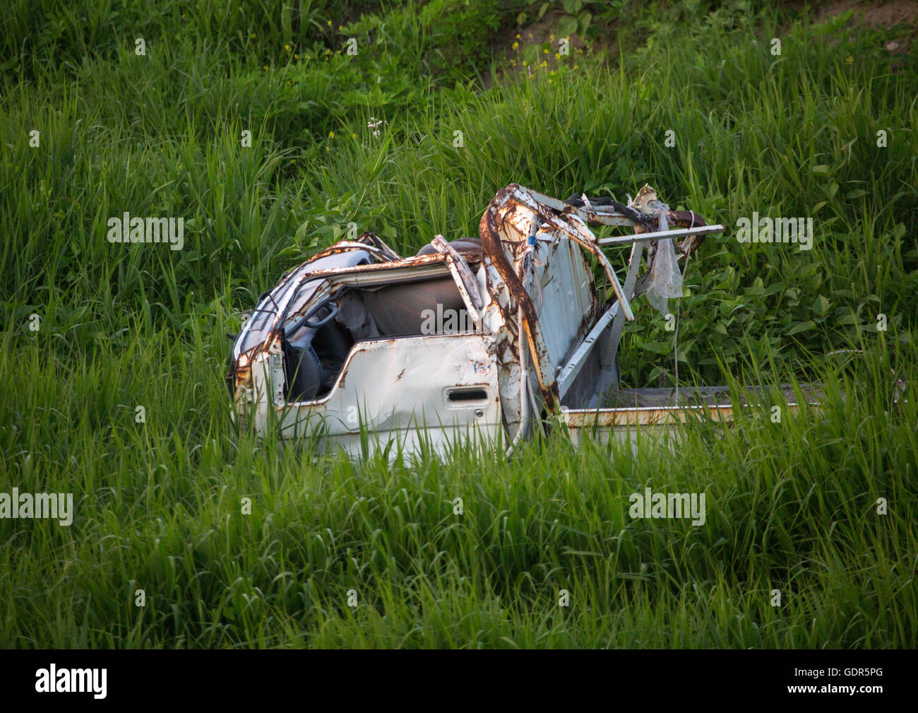 A destroyed and abandoned car by 2011 tsunami, Fukushima prefecture, Tomioka, Japan Stock Photo