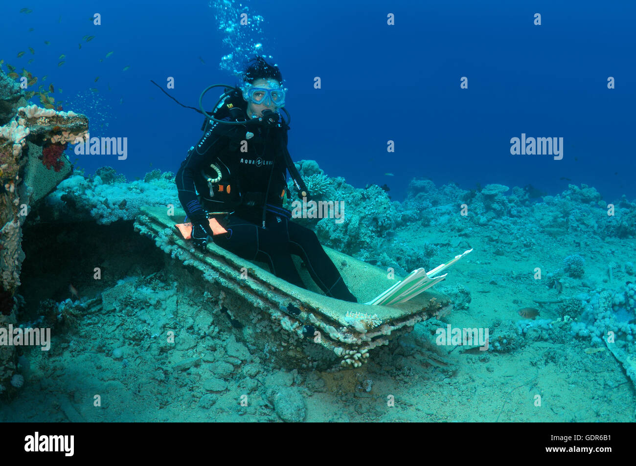 Female Scuba diver sitting in the bath on the Wreck of Yolanda, Shark Yolanda reef, Ras Mohammed national park, Sinai Stock Photo