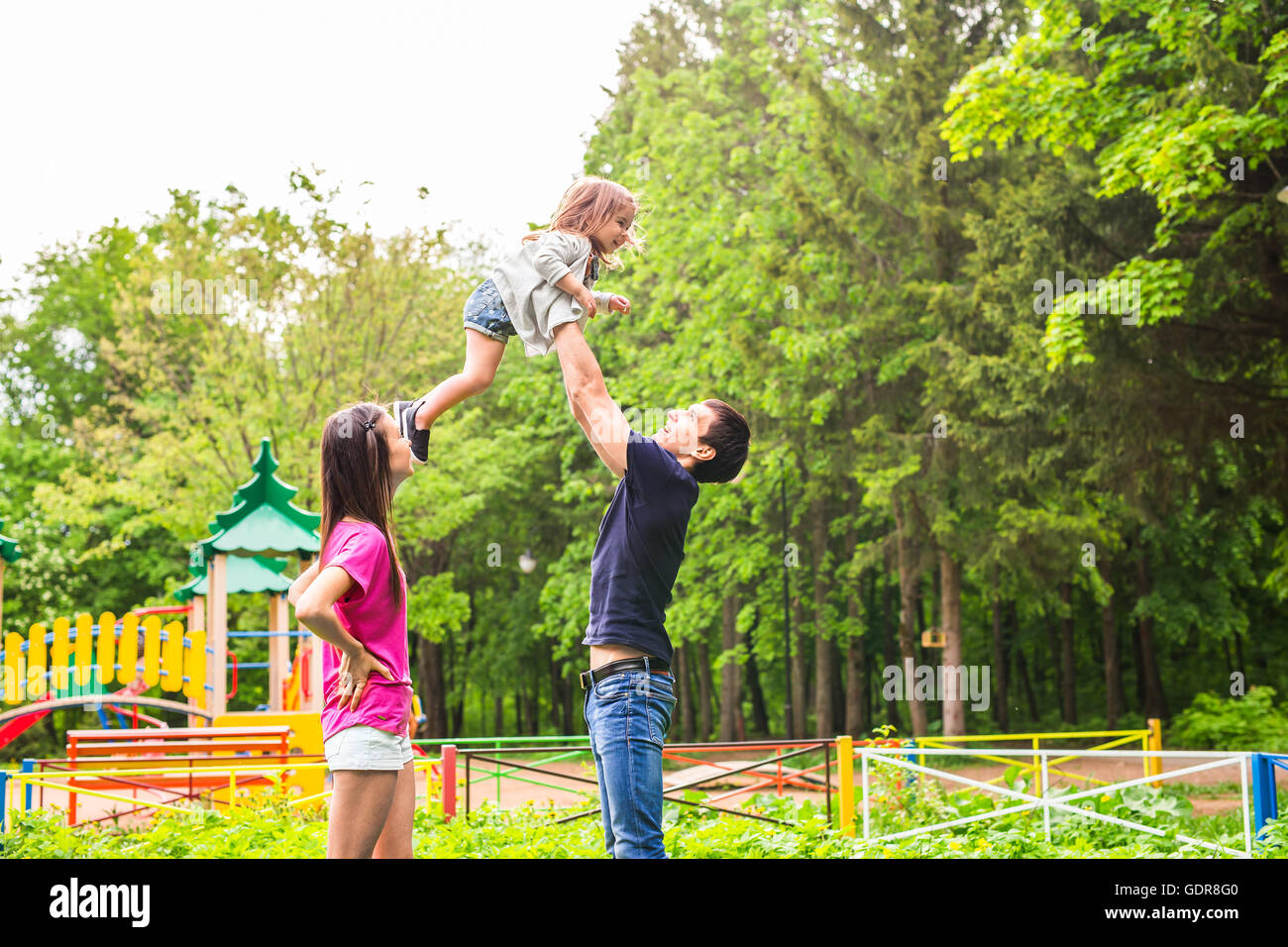 Happy mother, father and daughter in the park Stock Photo - Alamy