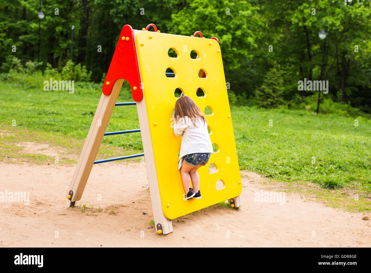 little girl on the summer playground Stock Photo - Alamy