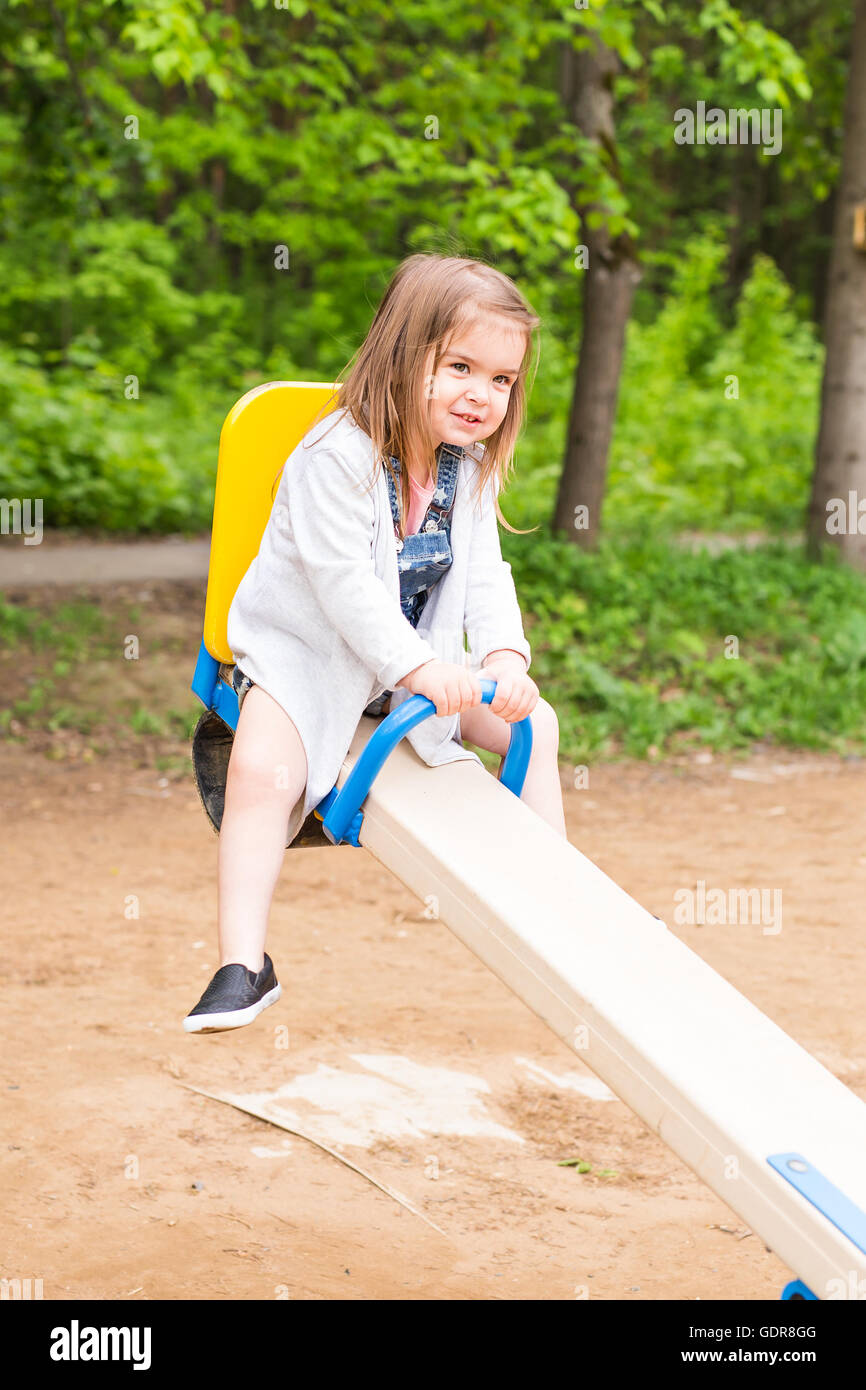 little girl on the summer playground Stock Photo - Alamy