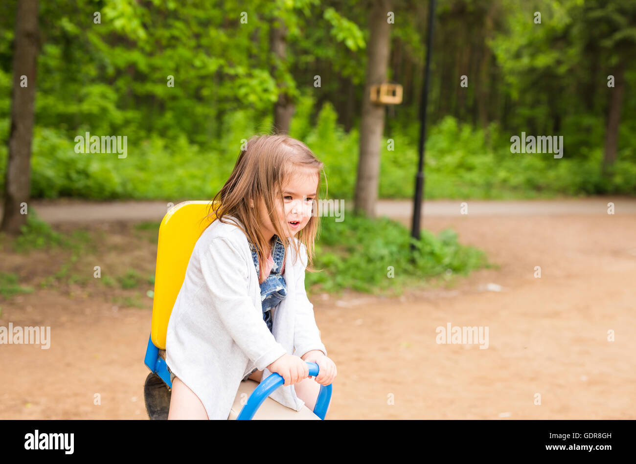 little girl on the summer playground Stock Photo - Alamy
