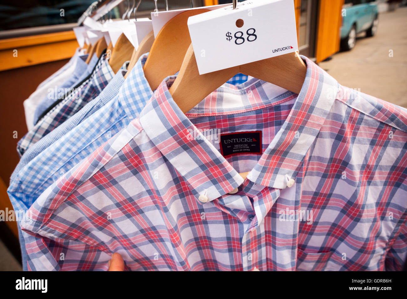 Detail of labels of shirts from the men's apparel company Untuckit at a branding event in Flatiron Plaza in New York on Saturday, July 16, 2016. Untuckit sells shirts through its website and several brick and mortar locations that are meant to be worn untucked. (© Richard B. Levine) Stock Photo