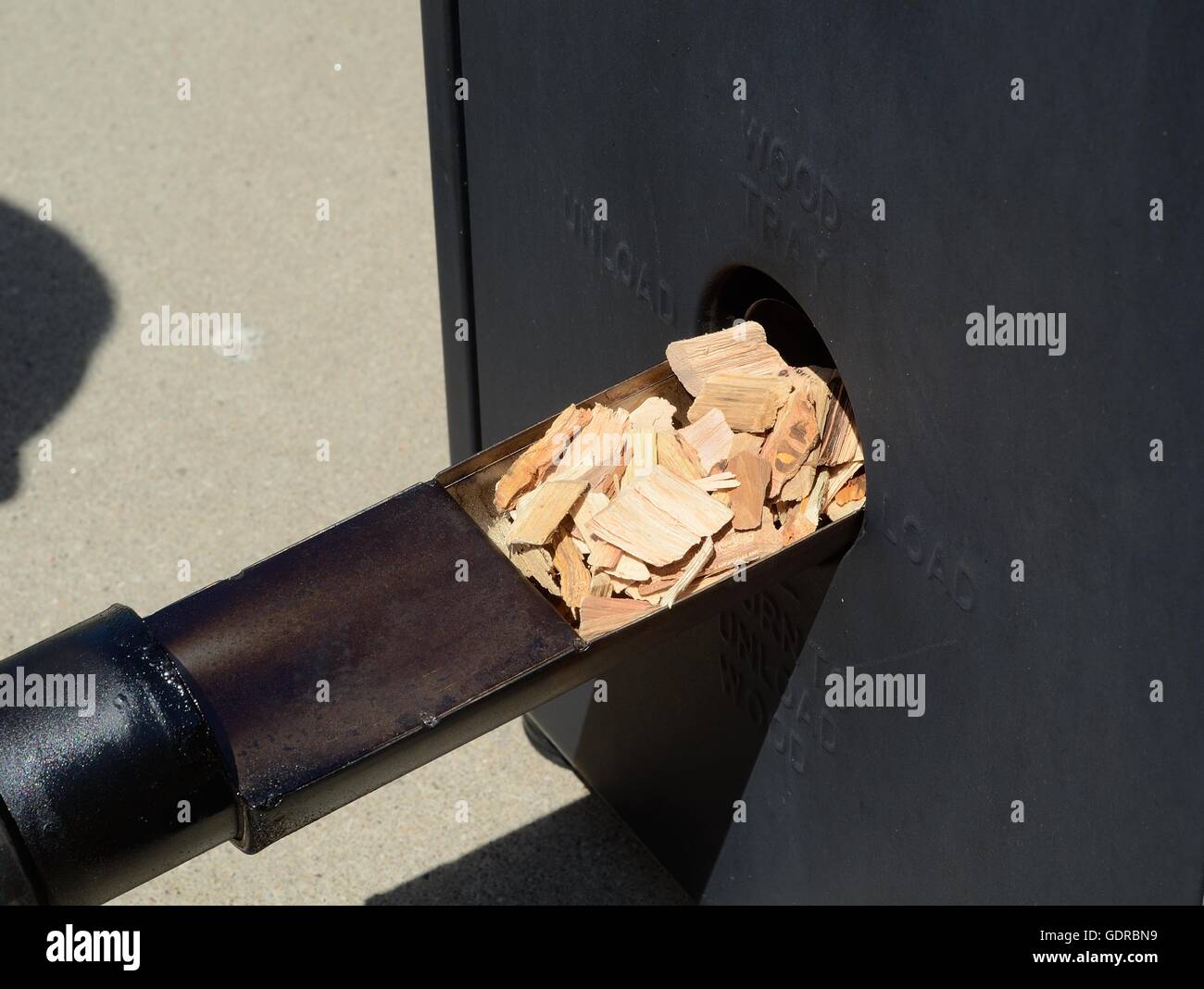 Putting Hickory Wood Chips in a Barbecue Smoker Stock Photo Alamy