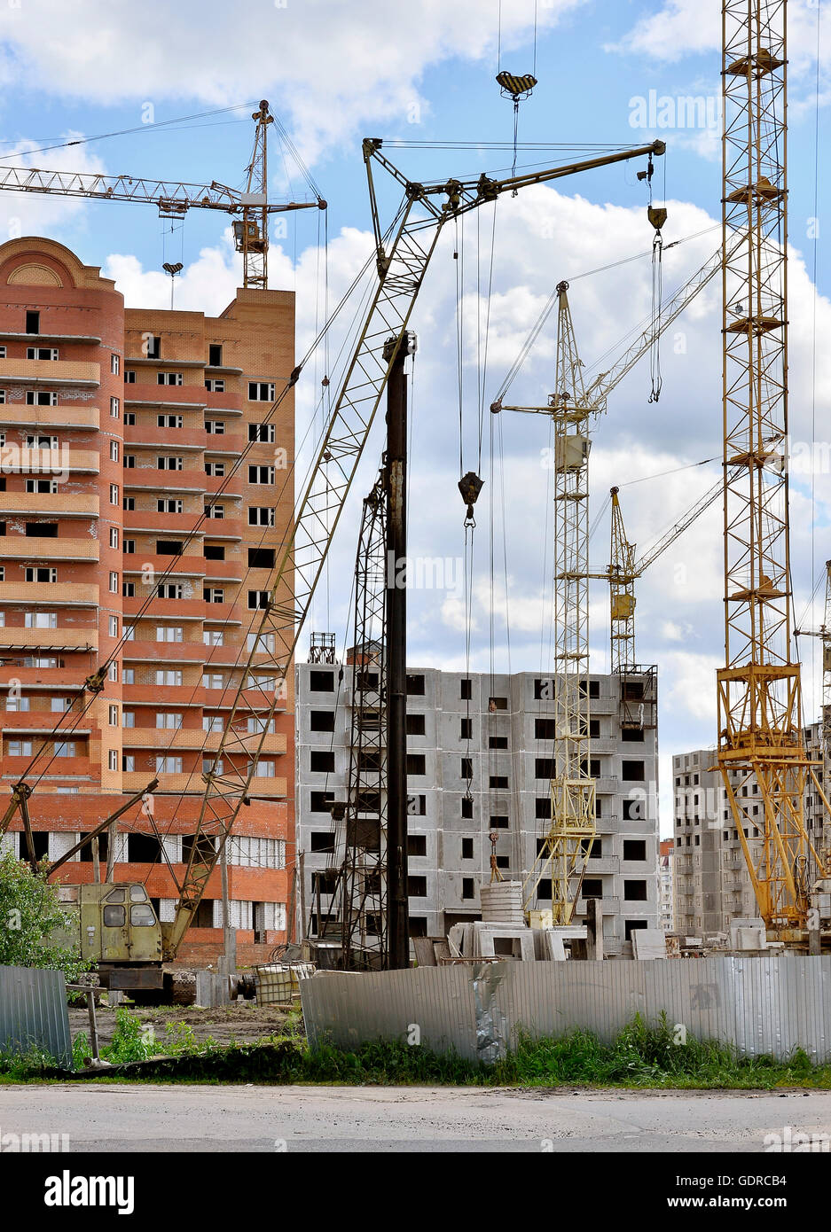 Construction site with cranes on sky background Stock Photo - Alamy