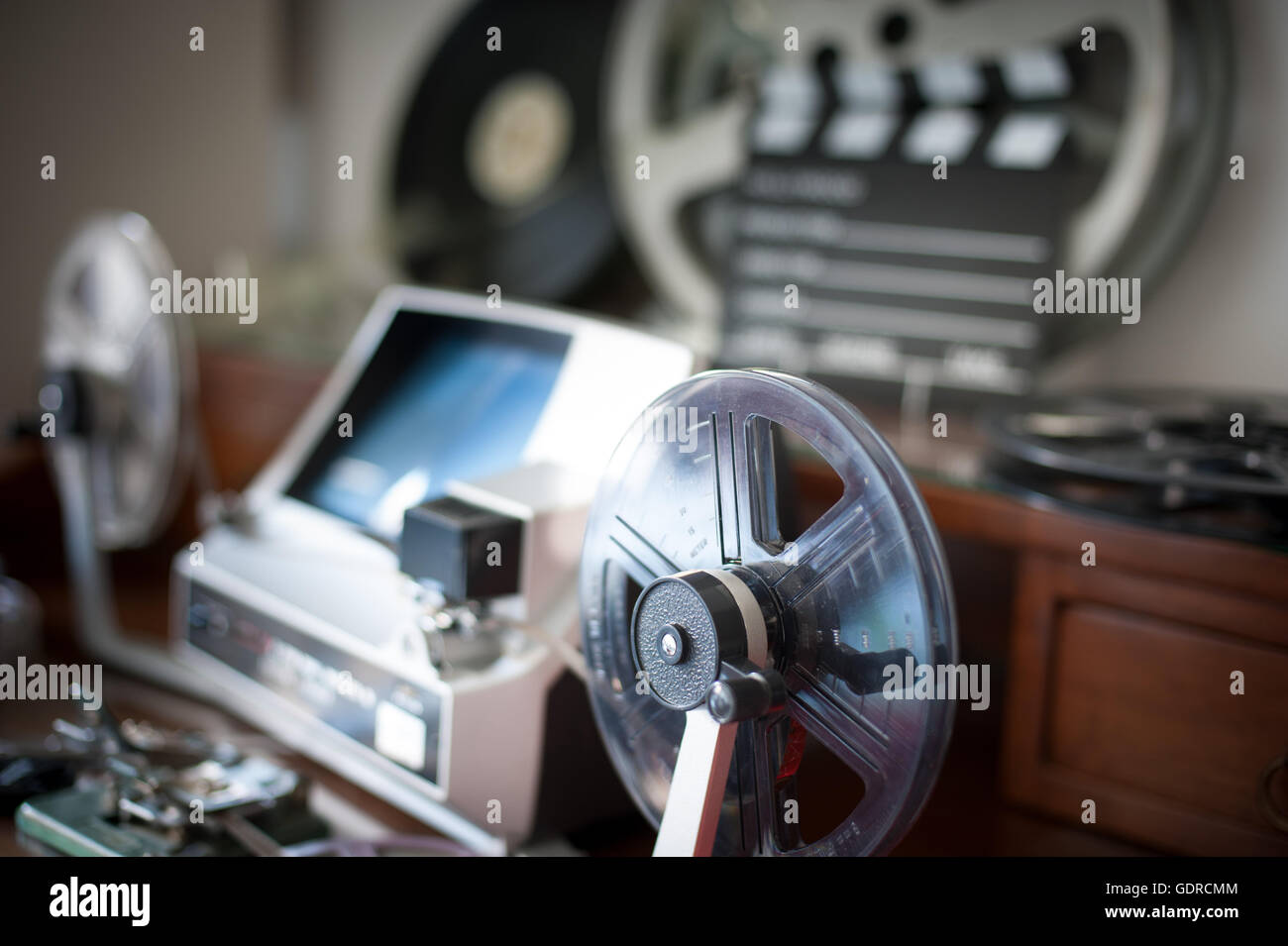 Super 8mm reel detail with desktop workspace for vintage movie editing out  of focus in background Stock Photo - Alamy