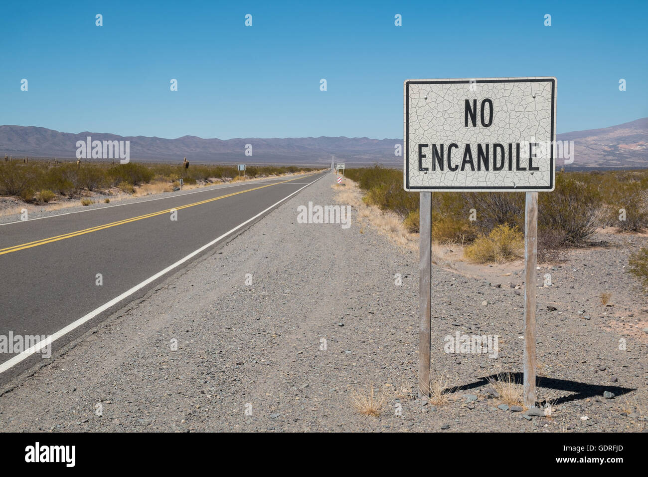 Andean road with Spanish traffic sign advising 'not to use hig beam' Stock Photo