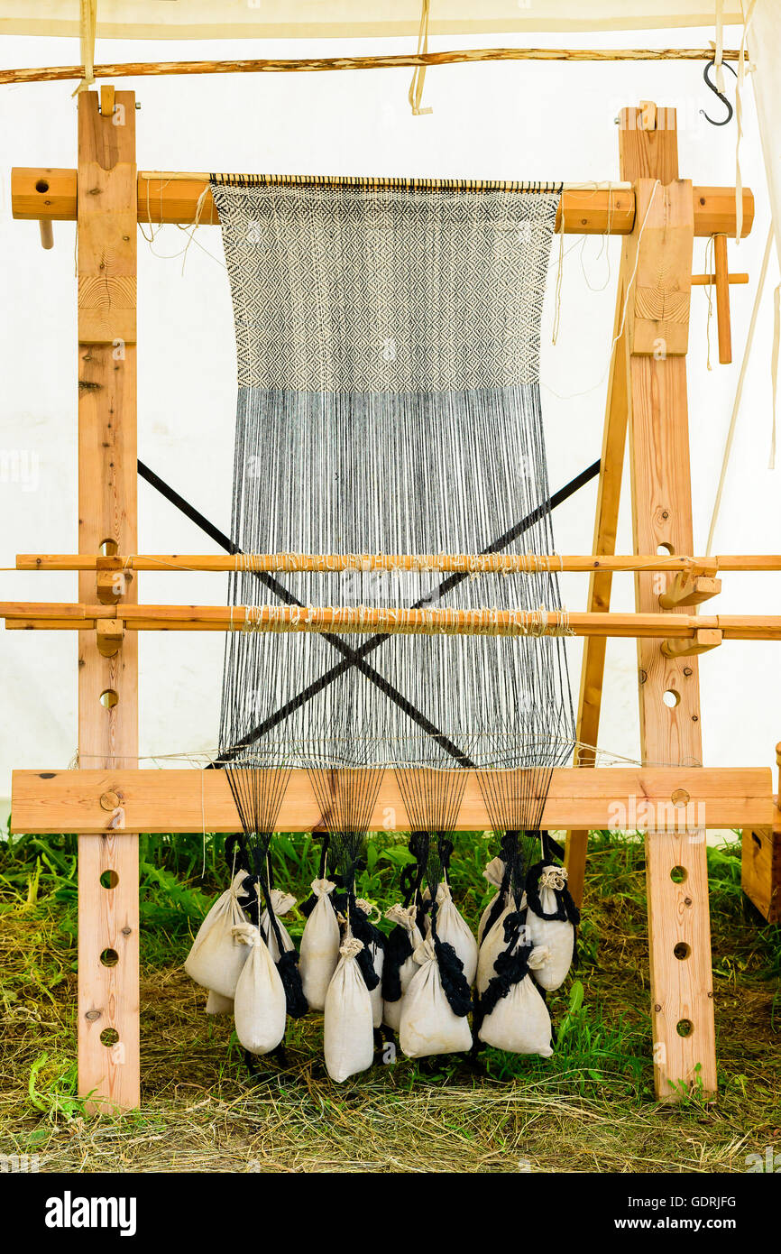 Weaving of a tablecloth or fabric on an old antique vertical loom Stock  Photo - Alamy