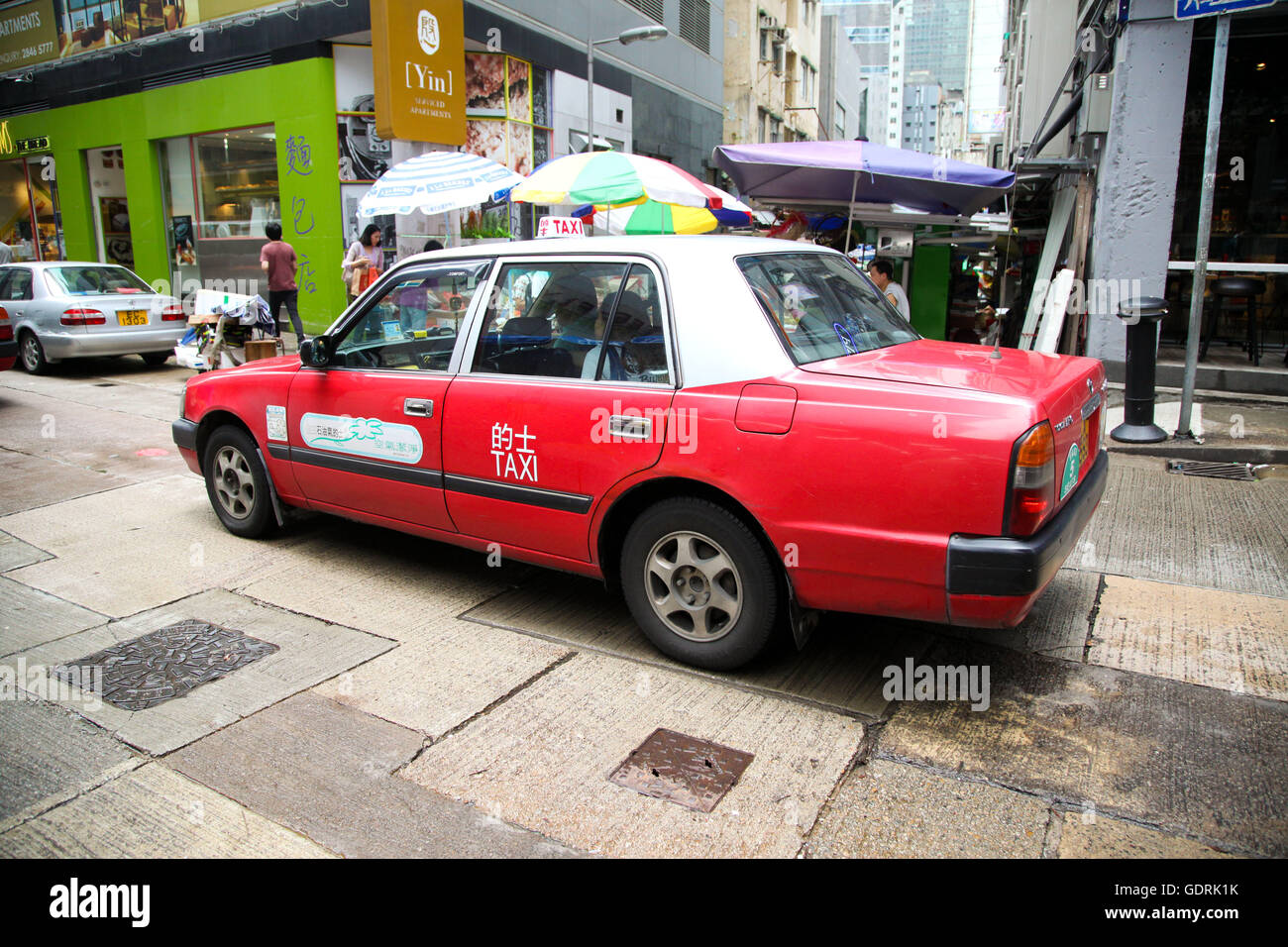 Red Hong Kong taxi in Central District of Hong Kong Stock Photo