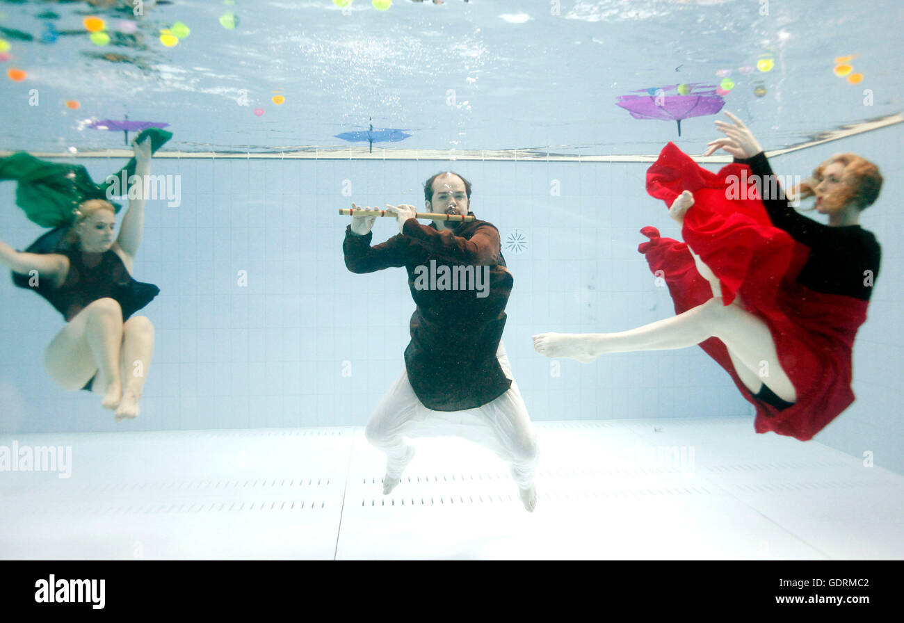 Jesse Banister (centre), composer of Synchronised, which opens the 52nd Billingham International Folklore Festival of World Dance on August 13th at Billingham Forum, Stockton-on-Tees and dancers Rhiannon Davison (left) and Beth Bracegirdle of the Balbir Singh Dance Company, practice ahead of its opening at the Billingham Forumn pool. Stock Photo