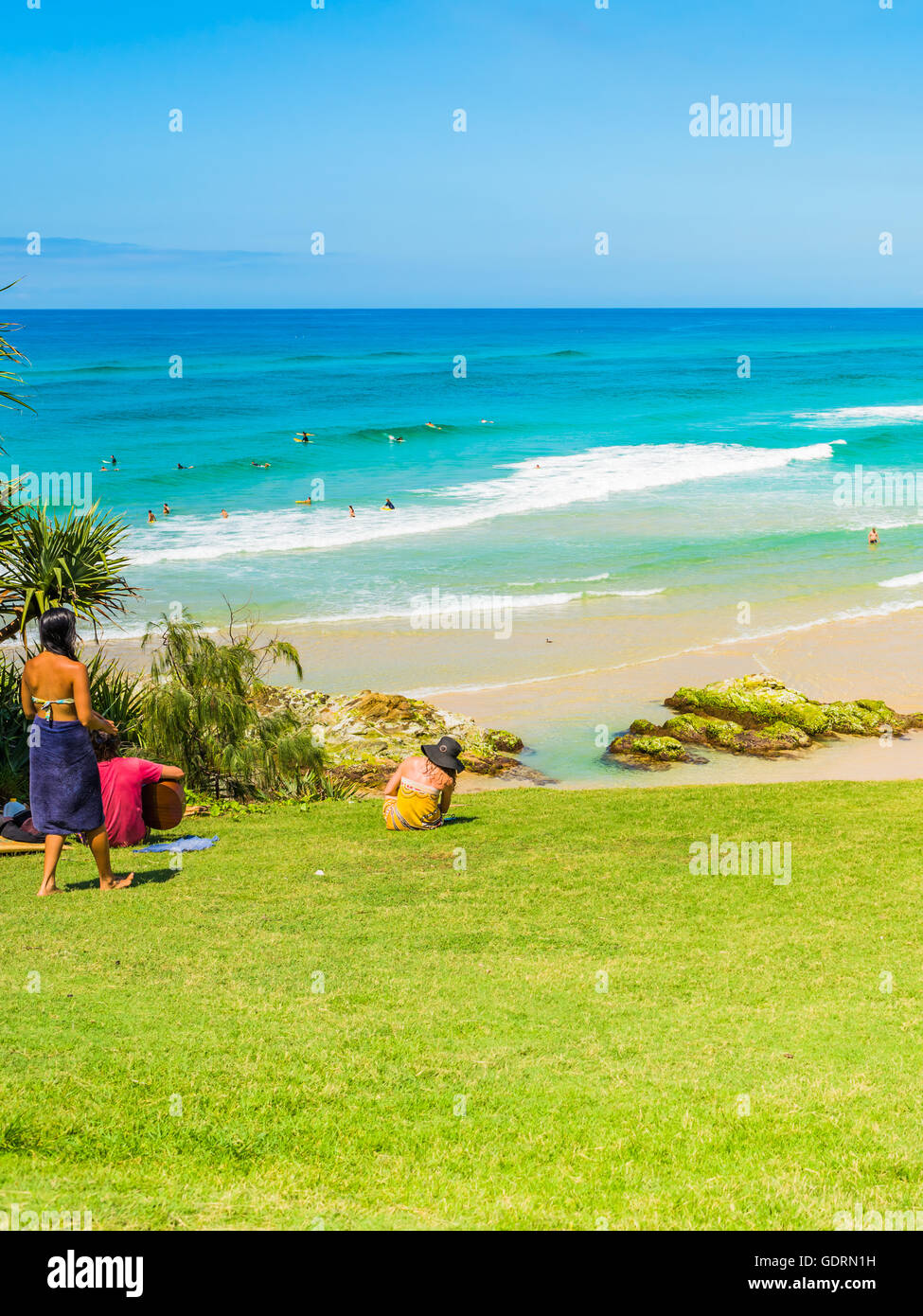 Playing a guitar and enjoying the view over North Stradbroke Island beach on a beautiful day in March Stock Photo