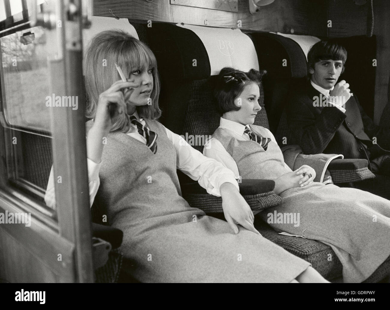 Ringo Starr with Prudence Bury and Pattie Boyd playing school girls on a Hard Days Night Train Stock Photo