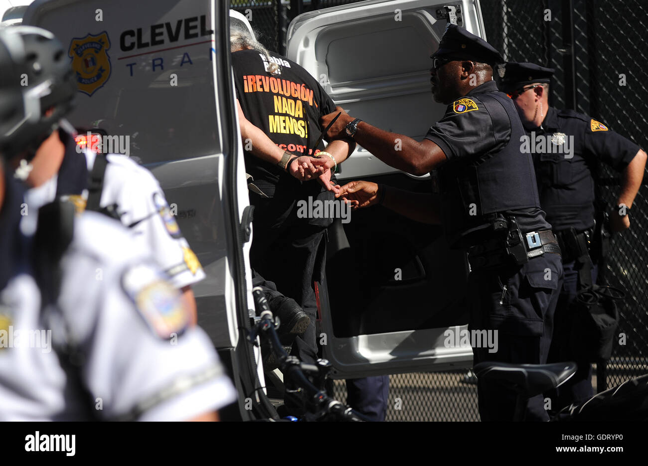 Cleveland, Ohio, USA. 20th July, 2016. A member of the Revolutionary Communist Party is arrested and placed in a police van after the group attempted to burn a flag near the Quicken Loans Arena on day three of the 2016 Republican National Convention. Credit:  Paul Hennessy/Alamy Live News Stock Photo
