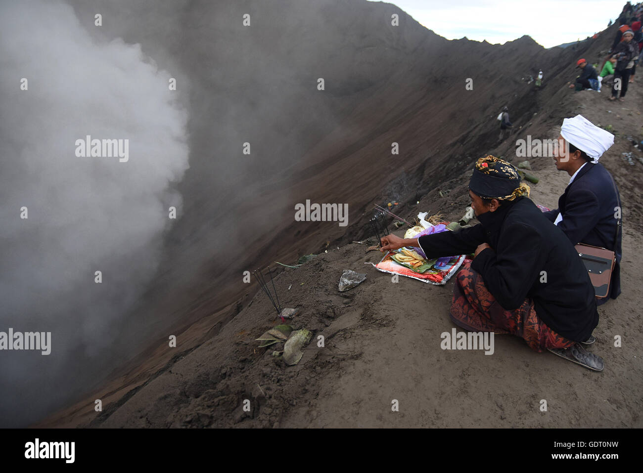 Probolinggo, East Java, Indonesia. 21st July, 2016. A Tenggerese worshipper throws chickens and vegetables for an offering of Mount Bromo during the Yadnya Kasada Festival at crater of Mount Bromo. © Sijori Images/ZUMA Wire/Alamy Live News Stock Photo
