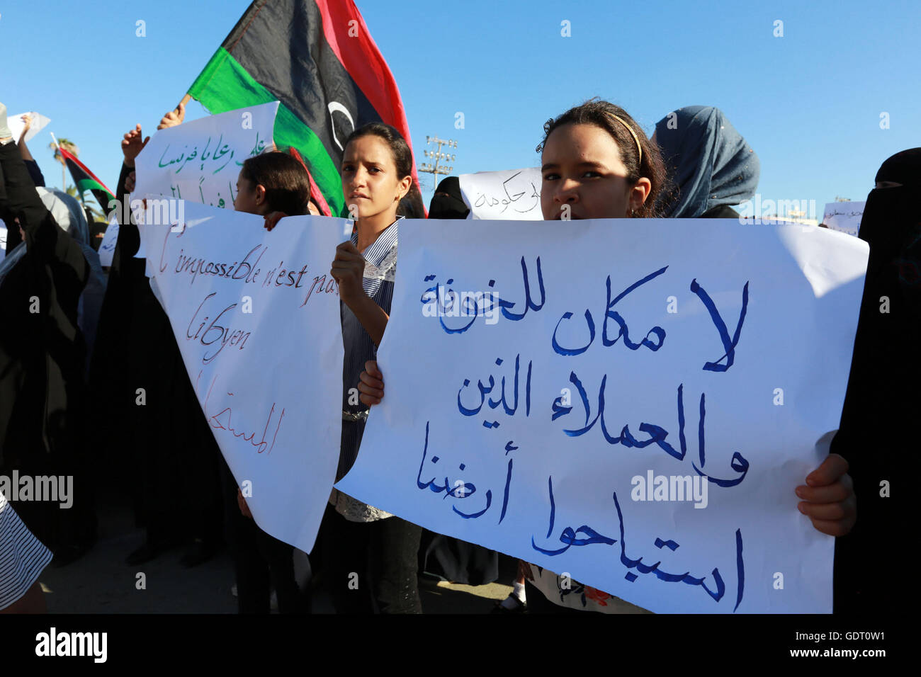 Tripoli, Libya. 20th July, 2016. Libyan girls hold placards during a demonstration to protest against the French military intervention at Martyrs' Square in Tripoli, capital of Libya, July 20, 2016. Three French soldiers have been killed in Libya where the country has special forces operating, the French Defence Ministry confirmed on Wednesday. Credit:  Hamza Turkia/Xinhua/Alamy Live News Stock Photo