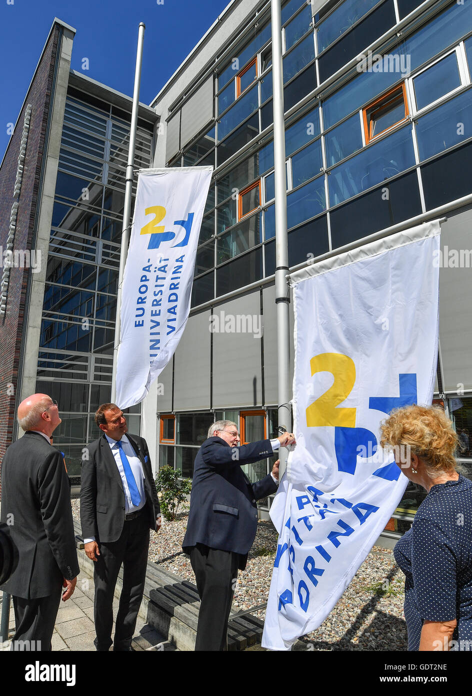 Alexander Woell (2-L), president of the Viadrina European University, raises a flag with other former rectors and presidents of the university, Hans N. Weiler (2-R), Gesine Schwan (R) and Gunter Pleuger (L) to mark the 25th anniversary of the university in Frankfurt/Oder, Germany, 21 July 2016. A ceremonial act marking the 25th anniversary of the Viadrina European University was held on the same day. Photo: PATRICK PLEUL/dpa Stock Photo
