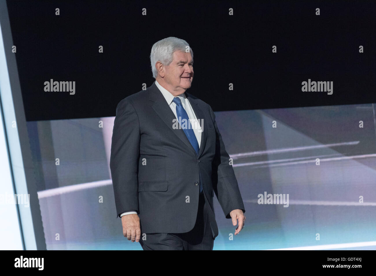 Former Speaker Newt Gingrich walks on to the stage after being