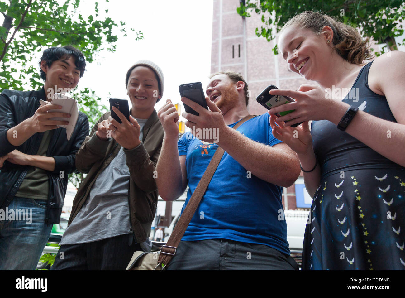 Tokyo, Japan. 22nd July, 2016. Fans try out Pokemon Go in Tokyo's Shinjuku district on July 22, 2016, Tokyo, Japan. The Pokemon Go app finally arrived in the land of the Pokemon on Friday 22, July two weeks after its launch in the United States. The release of the app in Japan had been rumoured for the past few days after the leak of details of a partnership deal with McDonalds Japan to create Pokemon Gyms in its 3,000 locations. Nintendo's market value has almost doubled since the app created by Niantic first launched in America. © Rodrigo Reyes Marin/AFLO/Alamy Live News Credit:  Aflo Co. Lt Stock Photo