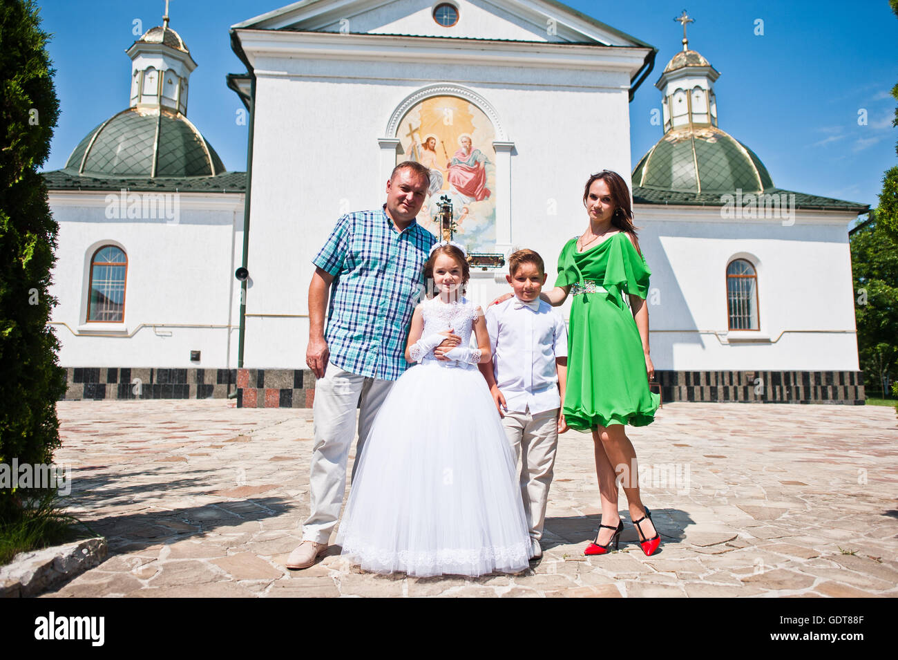 Happy family at first holy communion background church Stock Photo