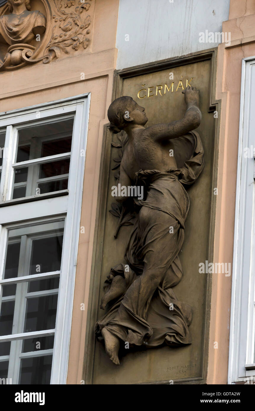 Stone statue writing on the facade of a building in the centre of Prague (Praha) in the Czech Republic Stock Photo