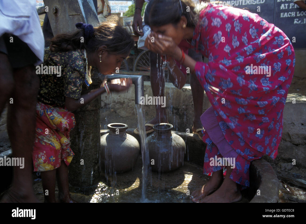 women at a water station in the province of Karnataka in India. Stock Photo
