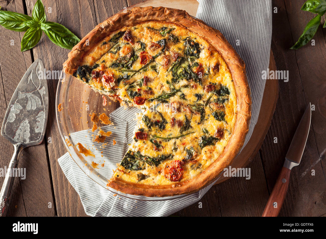 Homemade Cheesy Egg Quiche for Brunch with Spinach and Tomato Stock Photo