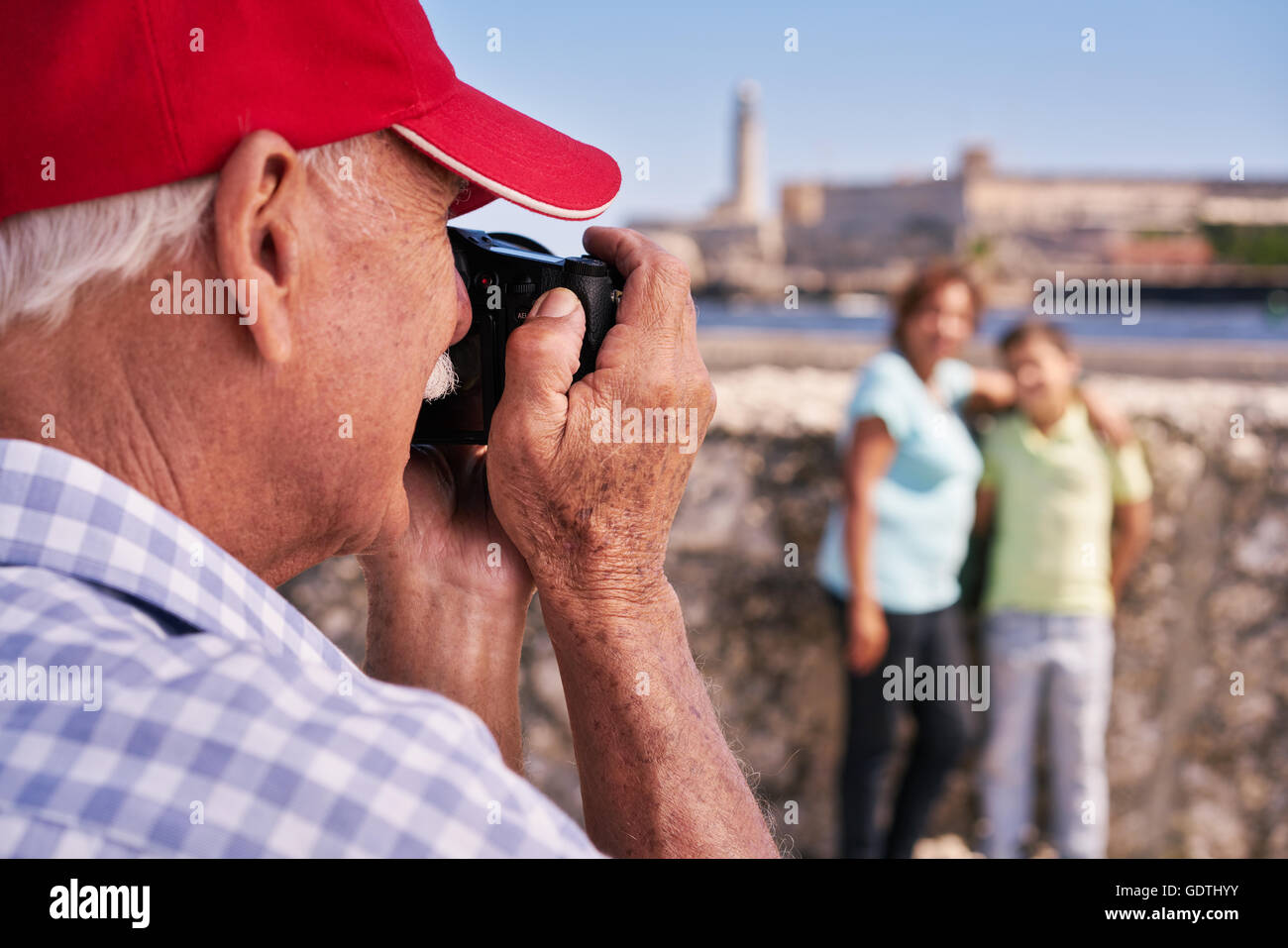 Happy tourists on holidays. Hispanic people traveling in Havana, Cuba. Grandfather, grandmother and grandchild during travel Stock Photo
