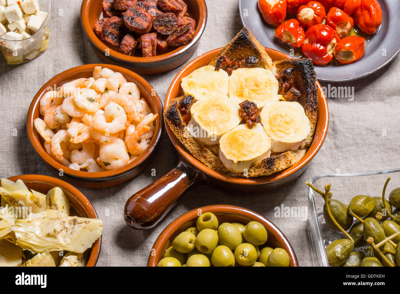 Tapas food, served in small bowls cold meat, goat cheese. A meal for