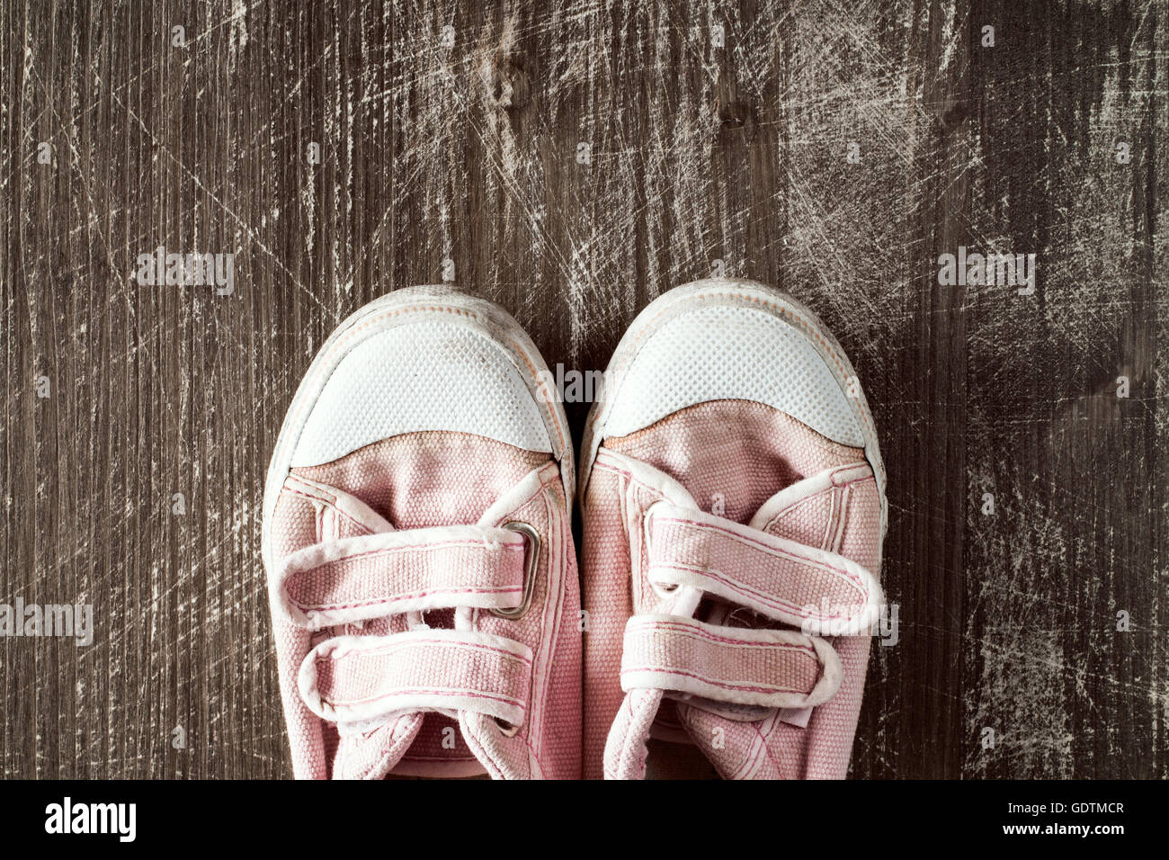 A pair of old pink sneakers on wooden surface.Top view Stock Photo - Alamy