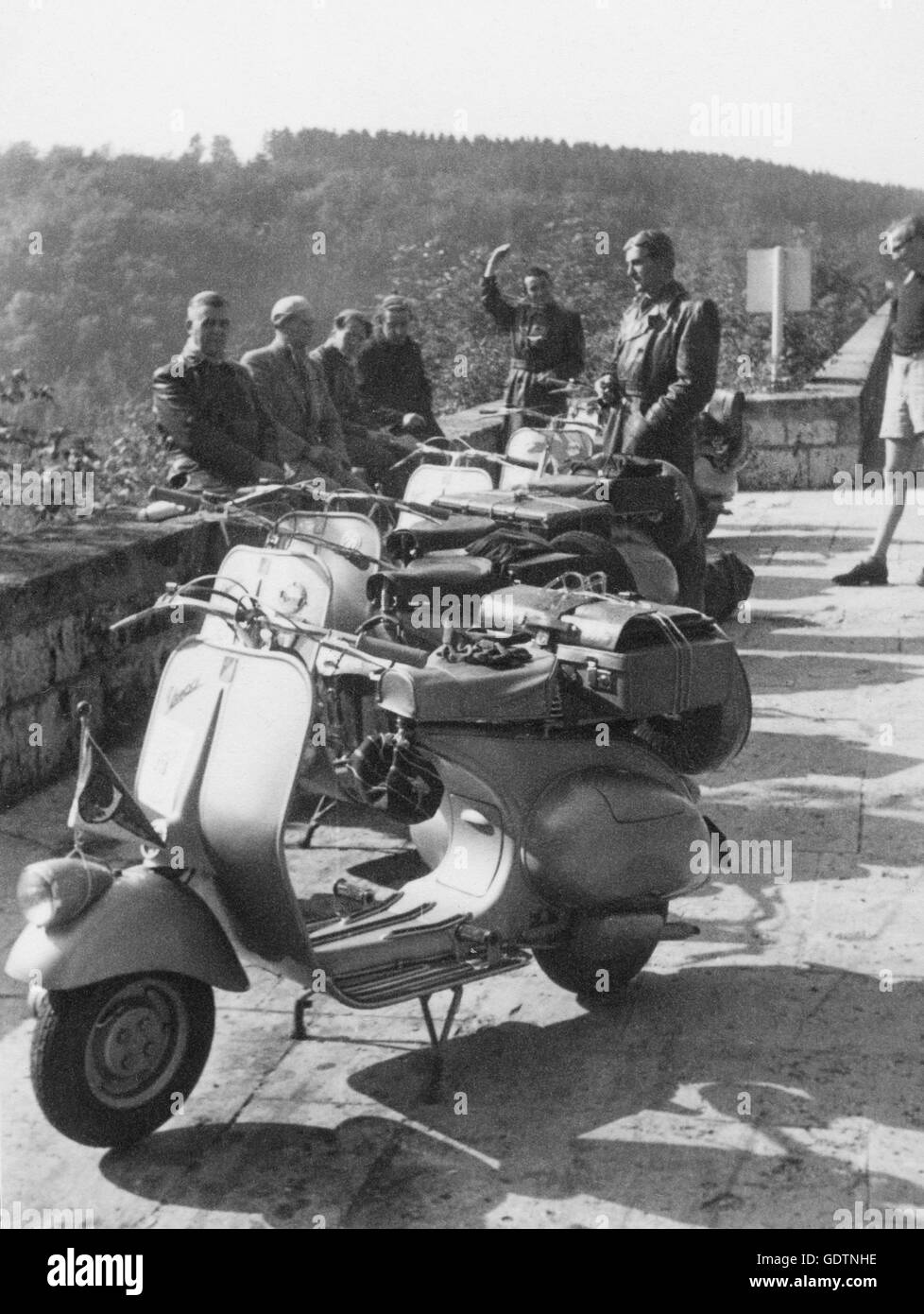 Vespas and owners on a viewing platform Stock Photo