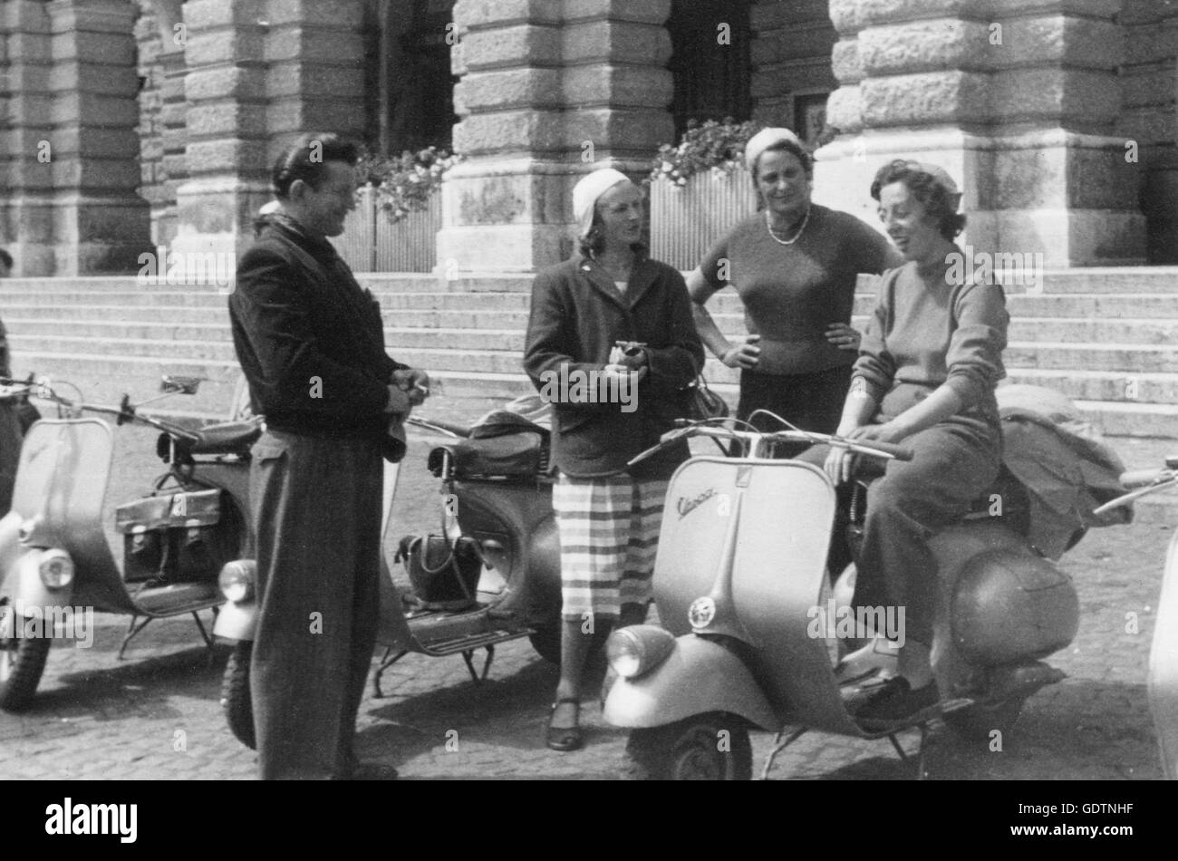 Vespa scooterists on public place in Augsburg Stock Photo