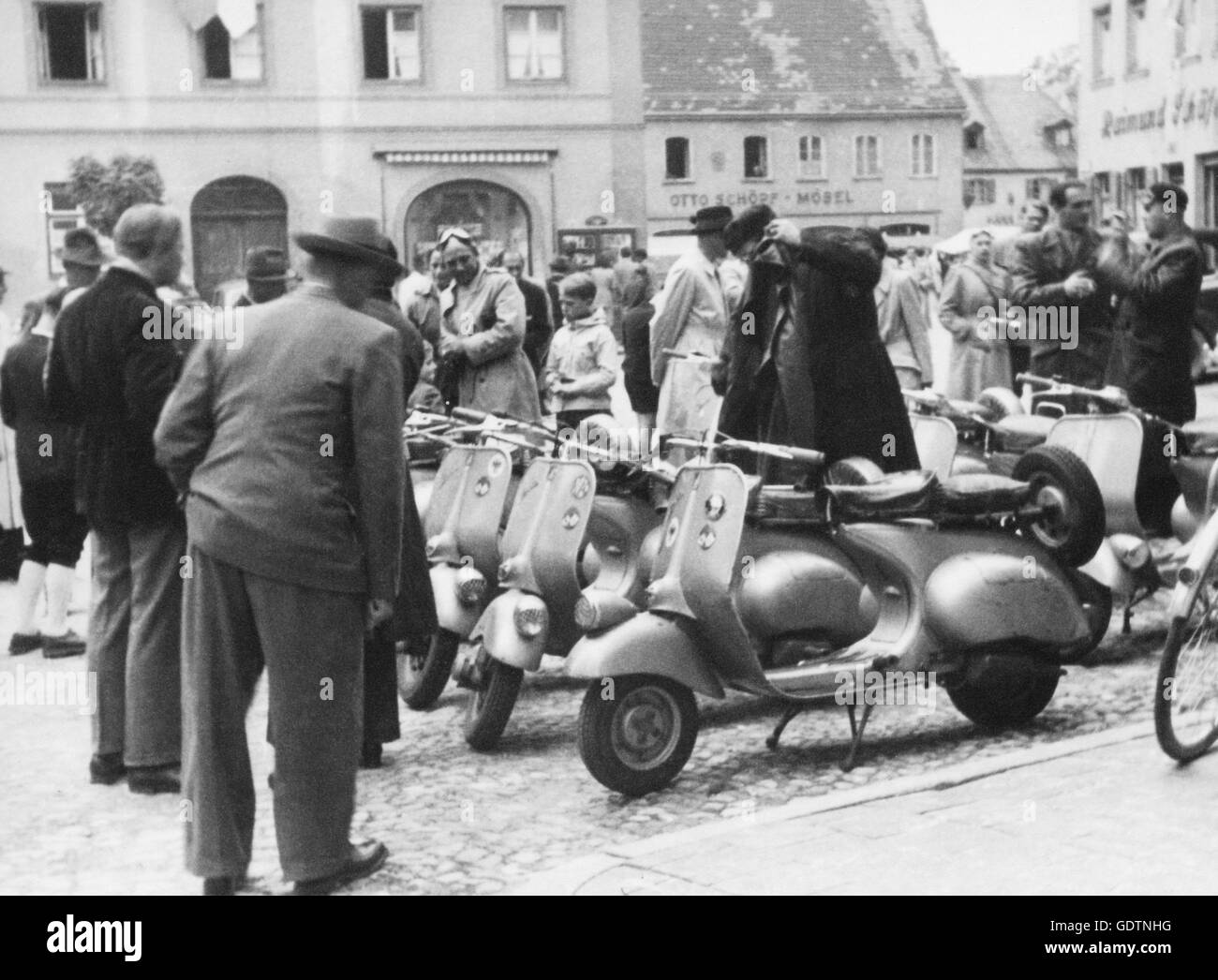 Passers-by looking at Vespas Stock Photo