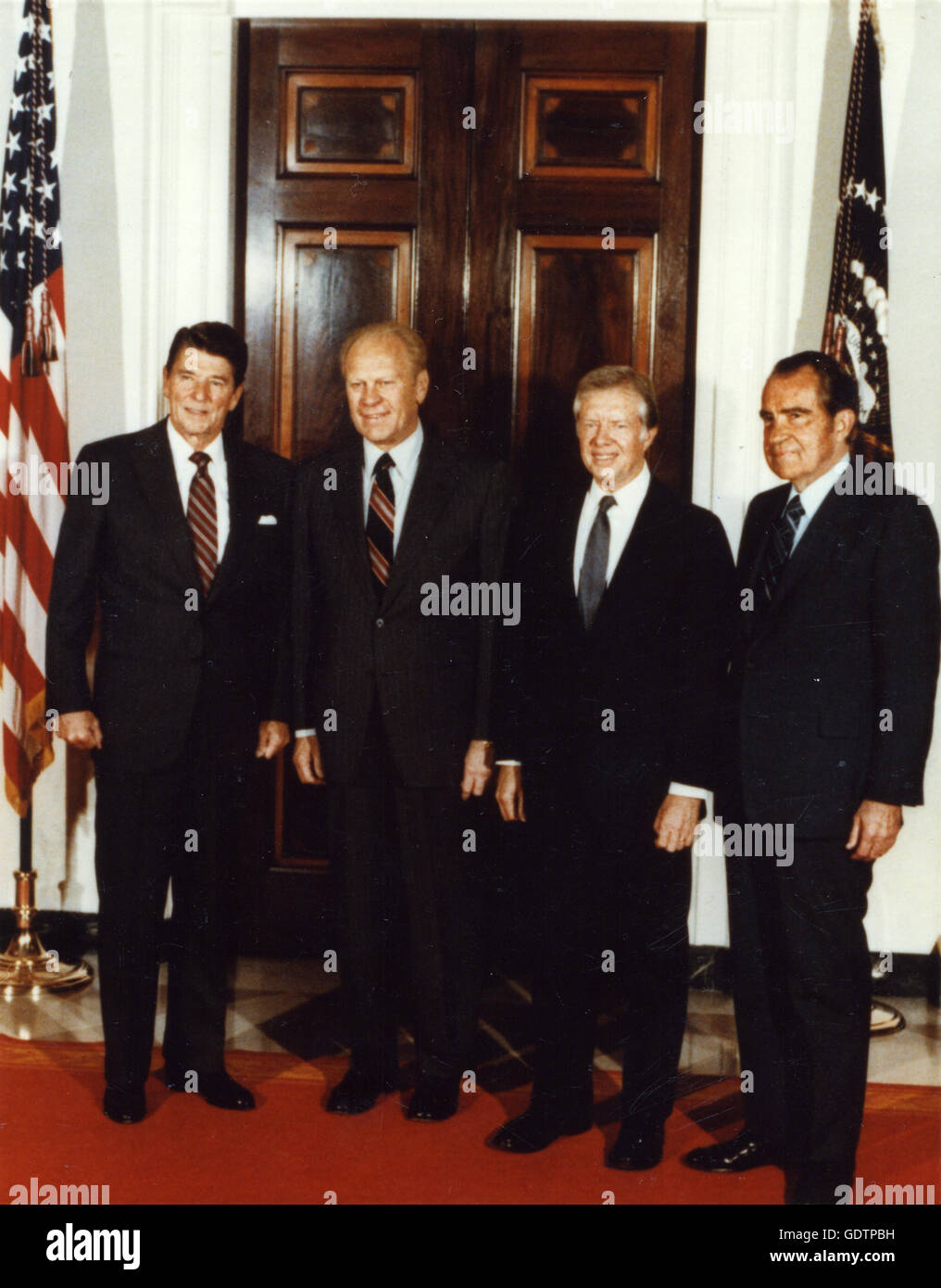 Full length portrait of President Ronald Reagan with former Presidents Gerald R. Ford, James E. Carter and Richard M. Nixon. Stock Photo
