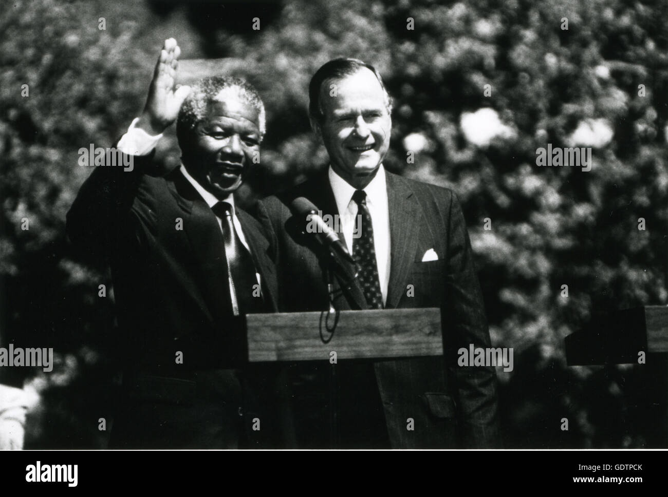 Nelson Mandela and George H.W. Bush wave to crowds at the White House. Stock Photo