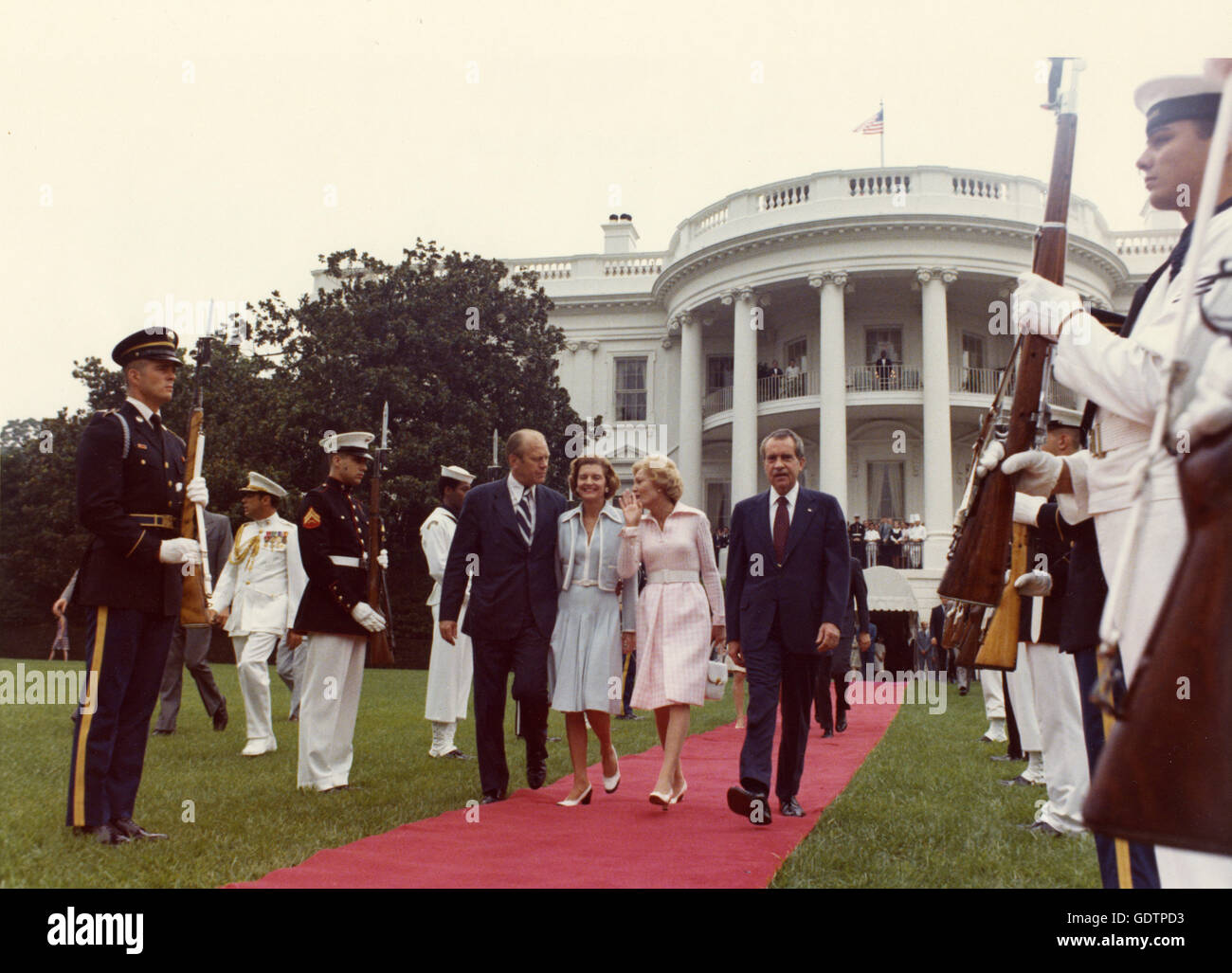 Vice-President Gerald R. Ford and wife Betty, walk President Richard Nixon and First Lady Pat Nixon to the helicopter on the White House South Lawn. Nixon's resignation became official at noon and Gerald Ford was sworn-in as President at 12:05. Stock Photo
