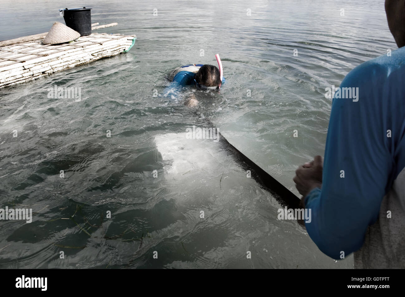 Coral collectors cut up a 'tombong rock', a coral stone, at the coral