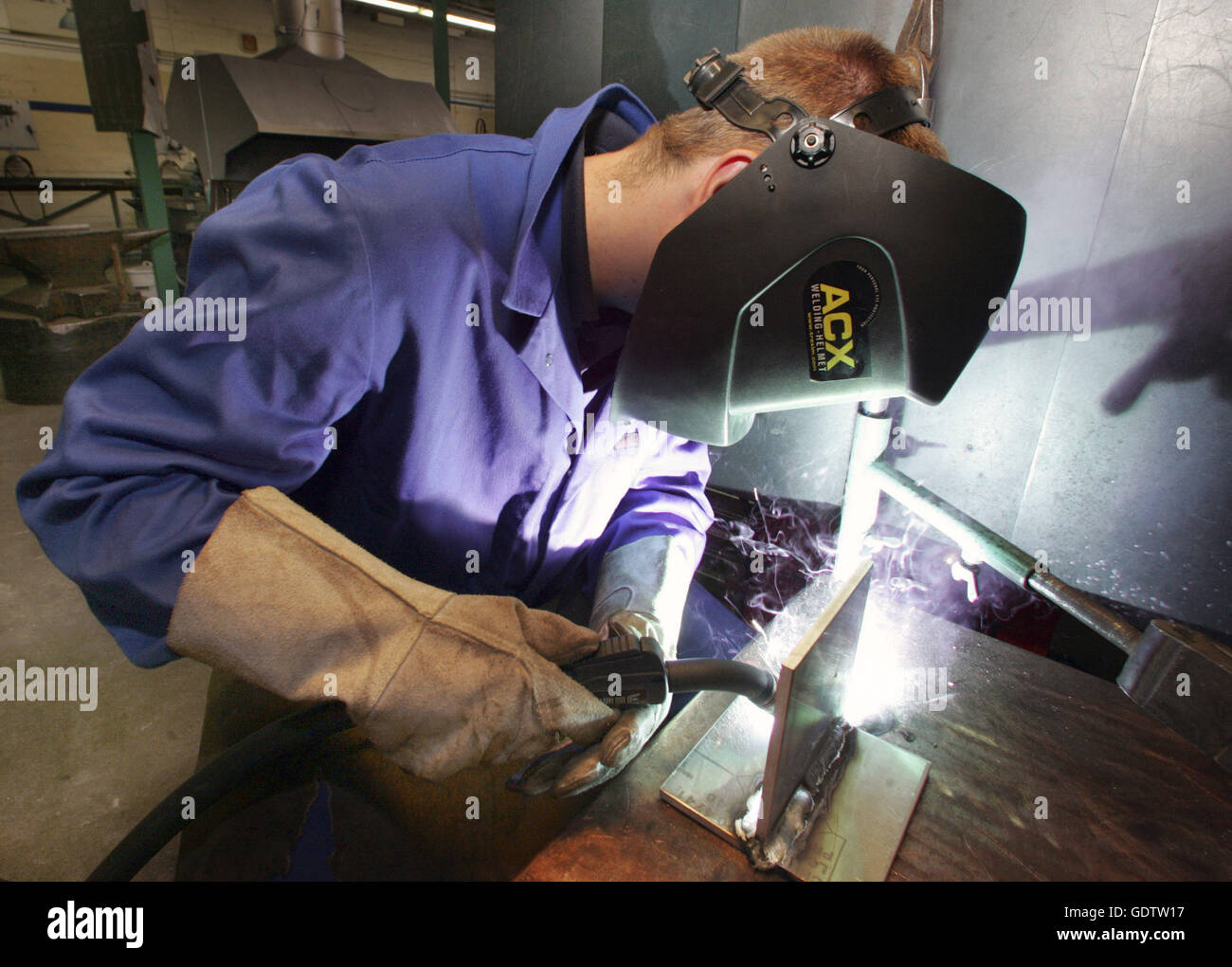 An apprentice learns to weld Stock Photo