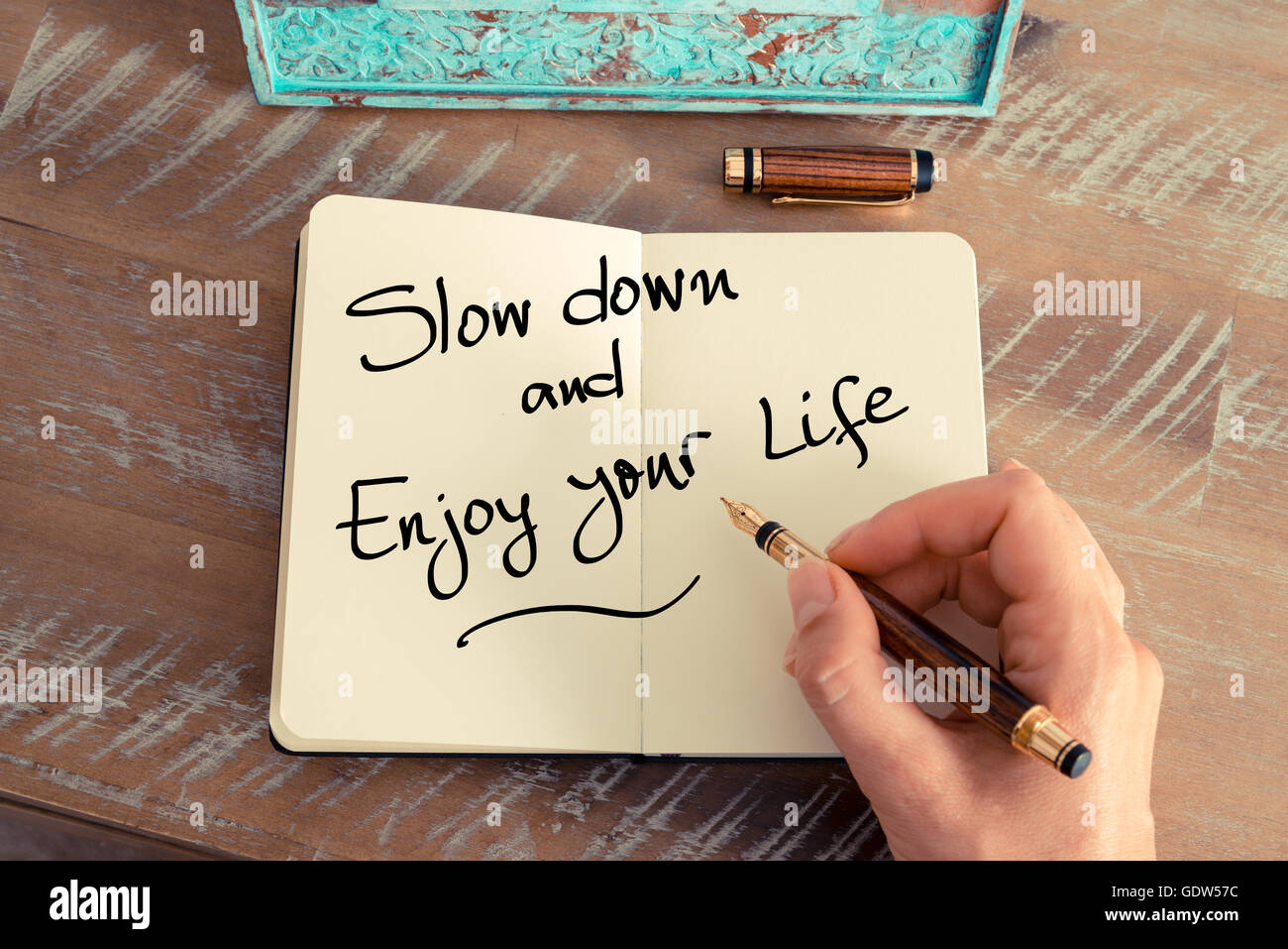 Handwritten text Slow Down and Enjoy Your Life as concept image. Stock Photo