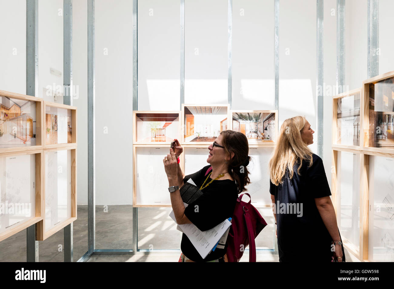 Interior view of pavilion displays and installations with visitors ...